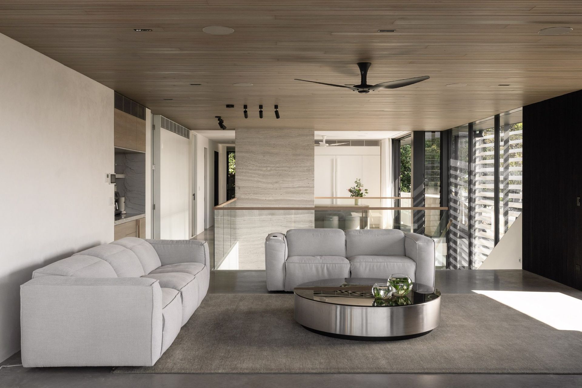 Decade House - Living Room. Upper living room with a timber lined ceiling and sculptural sofas.