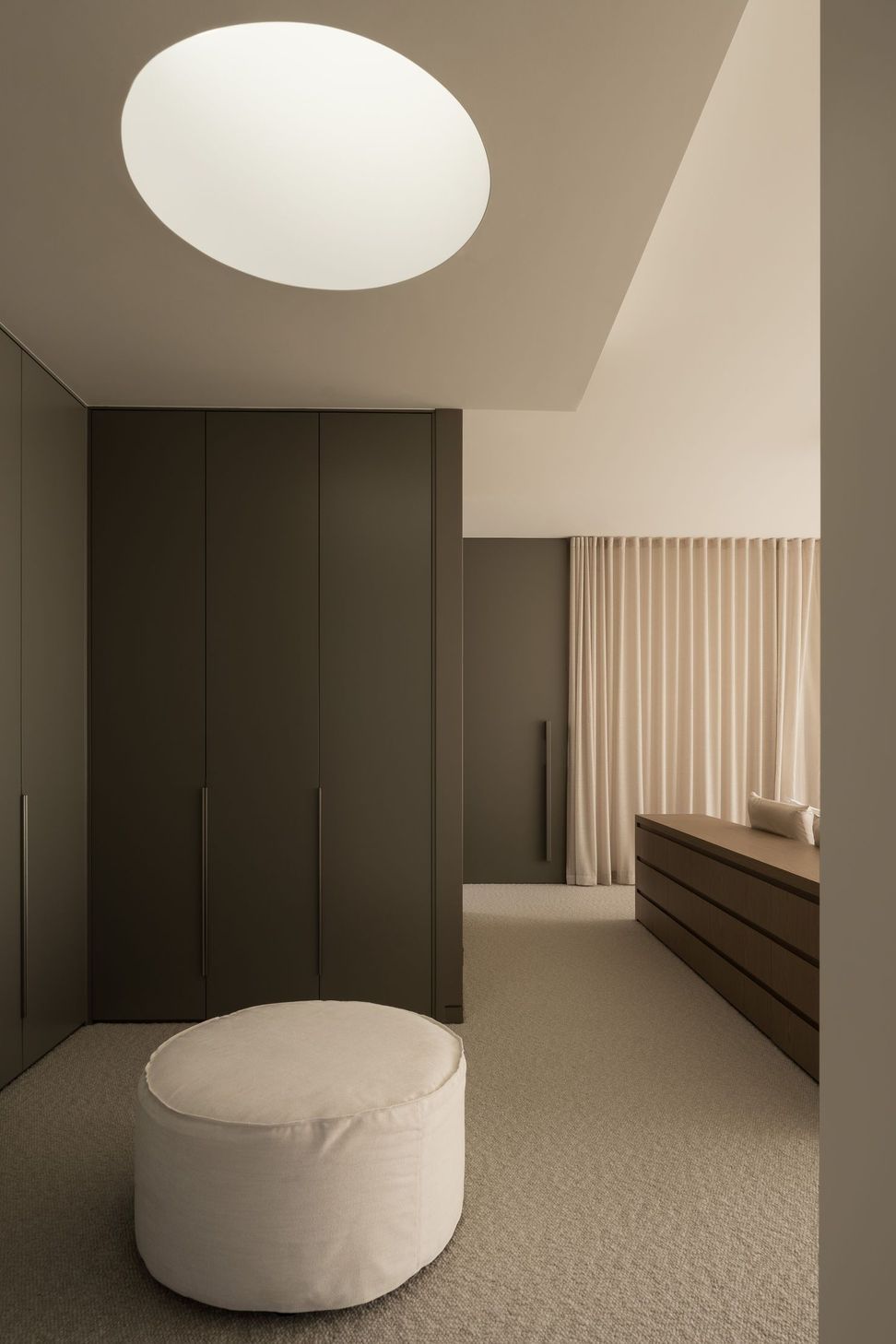 Solmere - Bedroom. Dark timber wardrobes leading through to the bedroom.