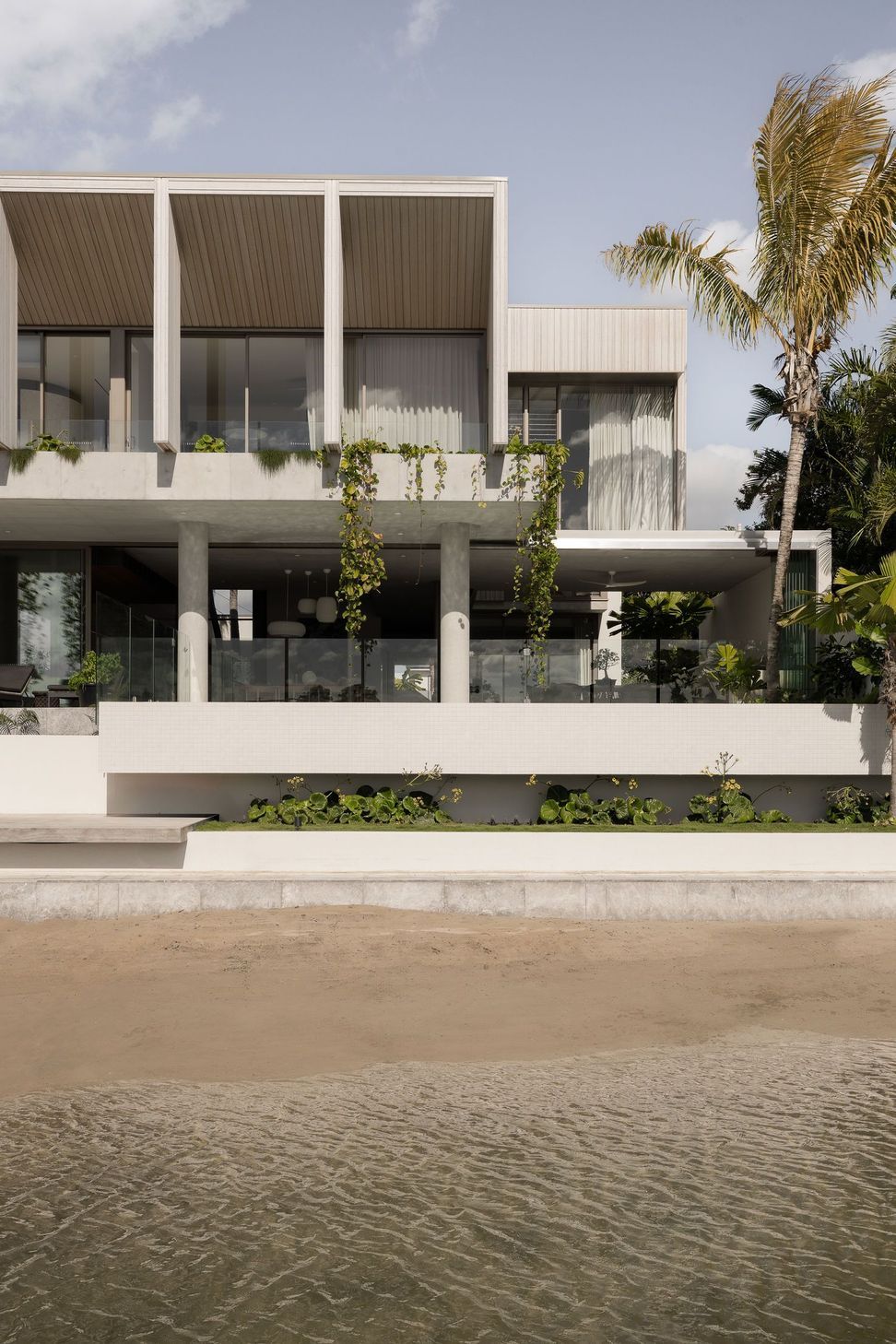 Solmere - Exterior. Layered terraces with glass balustrades and trailing greenery.