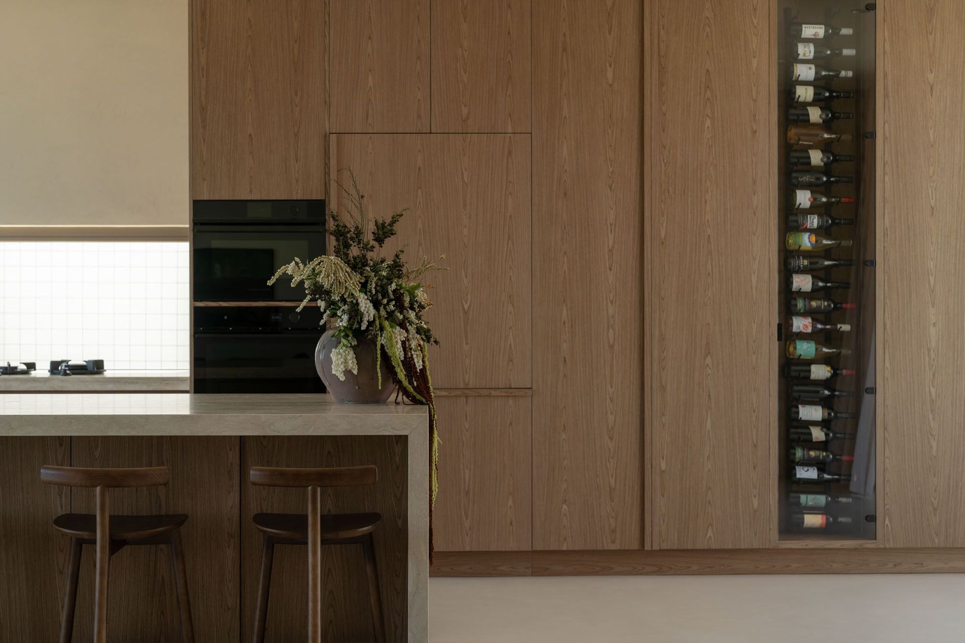 House on Pacific - Kitchen. Integrated ovens and fridge within warm timber joinery.