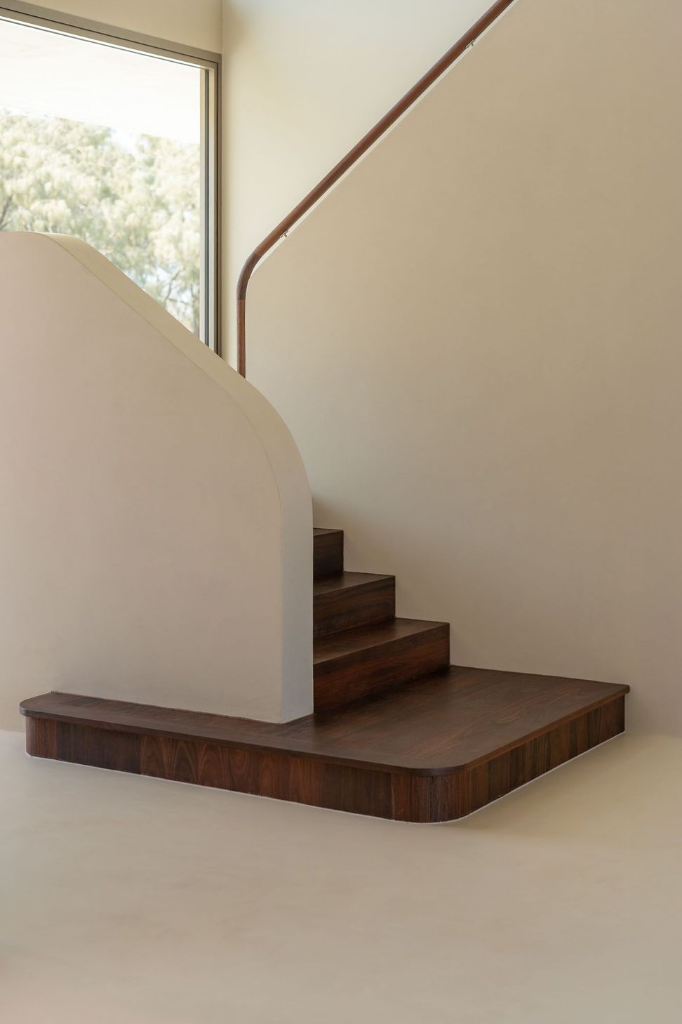 House on Pacific - Staircase. Sculpted stair with a solid balustrade and timber treads.