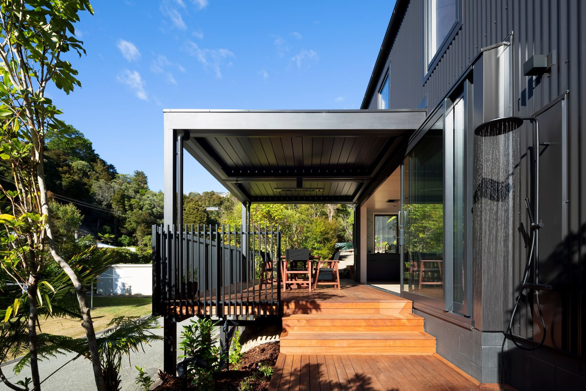 Operable louvres over the central deck increase the area of covered living space outside the small building footprint.”