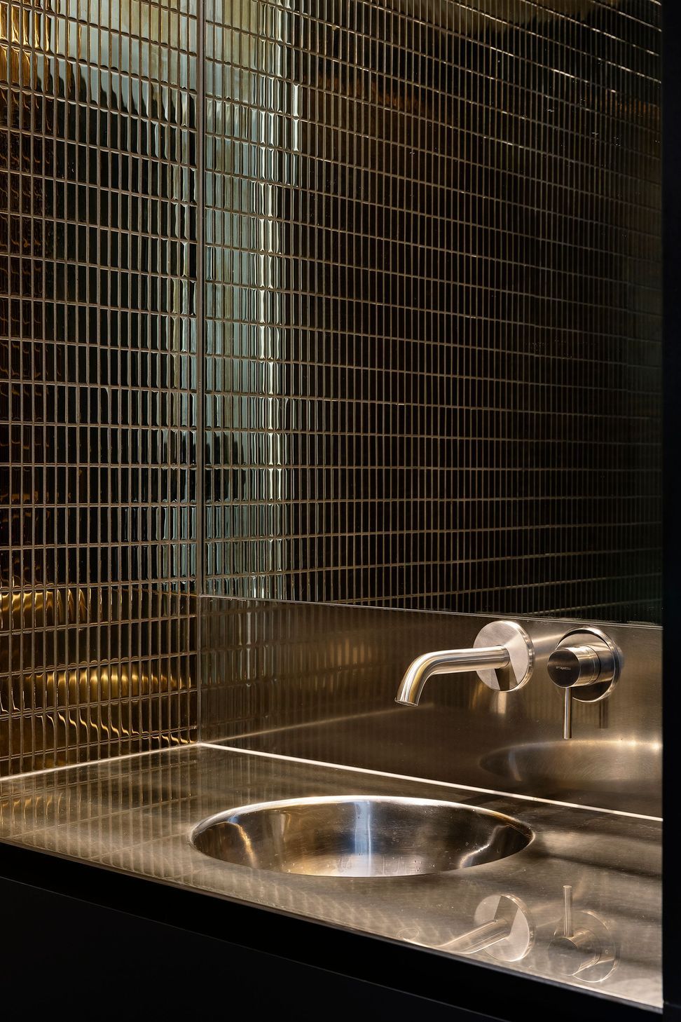 The tiles in the downstairs WC are dark and moody.