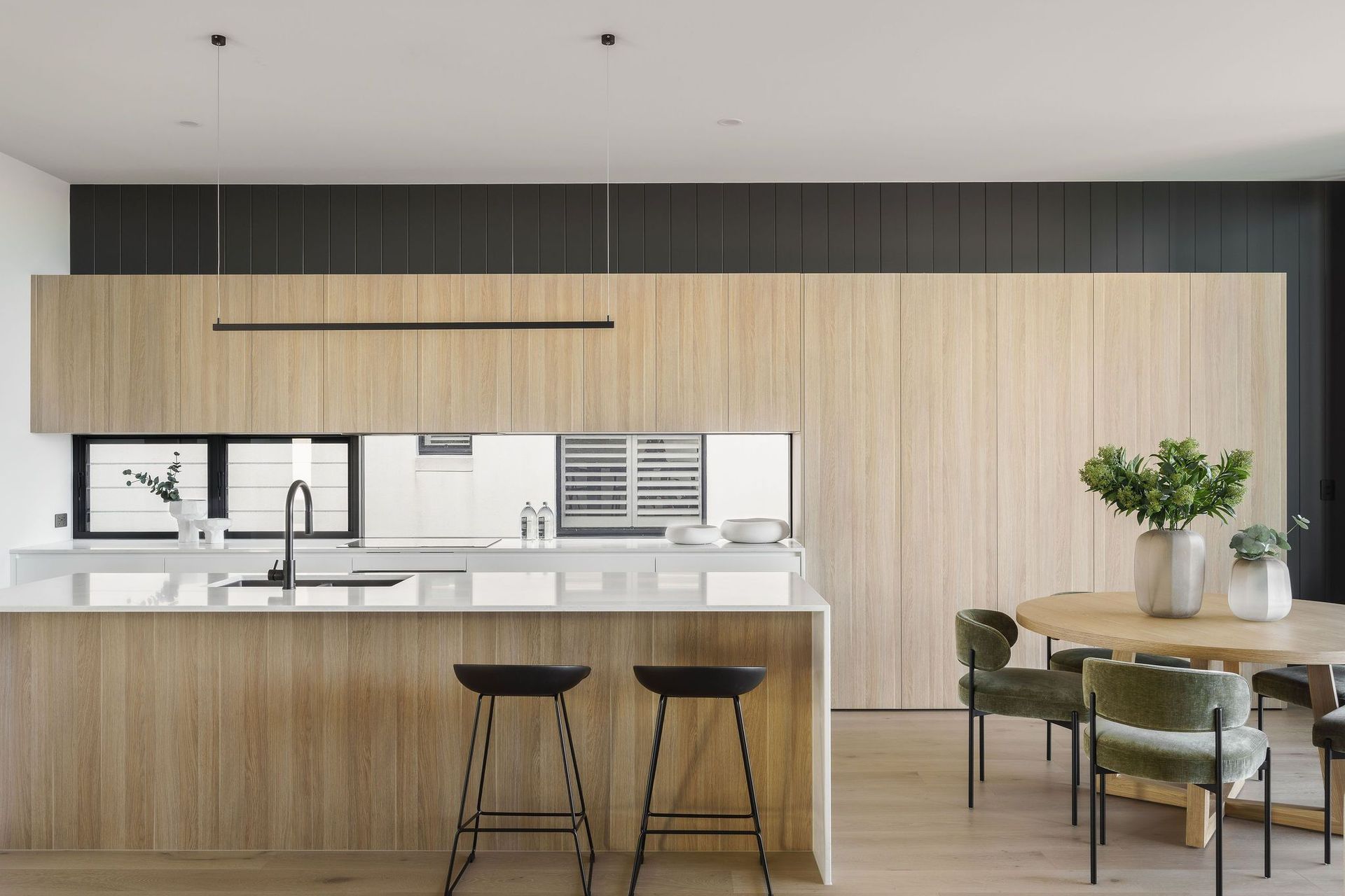 Gilbert Residence - Kitchen. Timber and white kitchen with a long island and dining area.