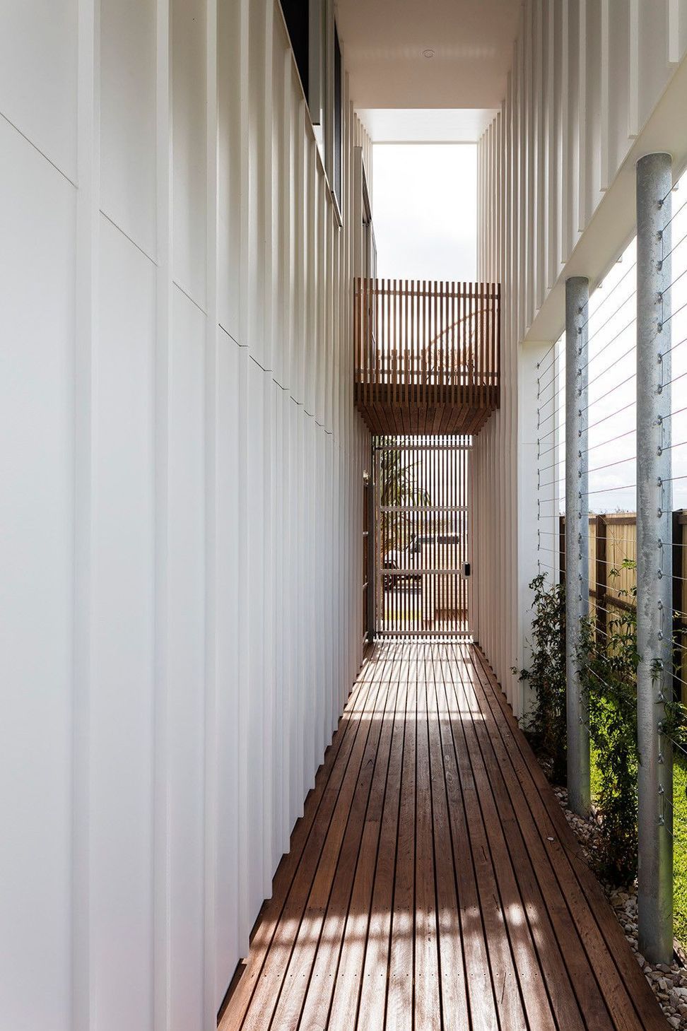 Viner Residence - Entry. Narrow side path leading between white walls to the entry.