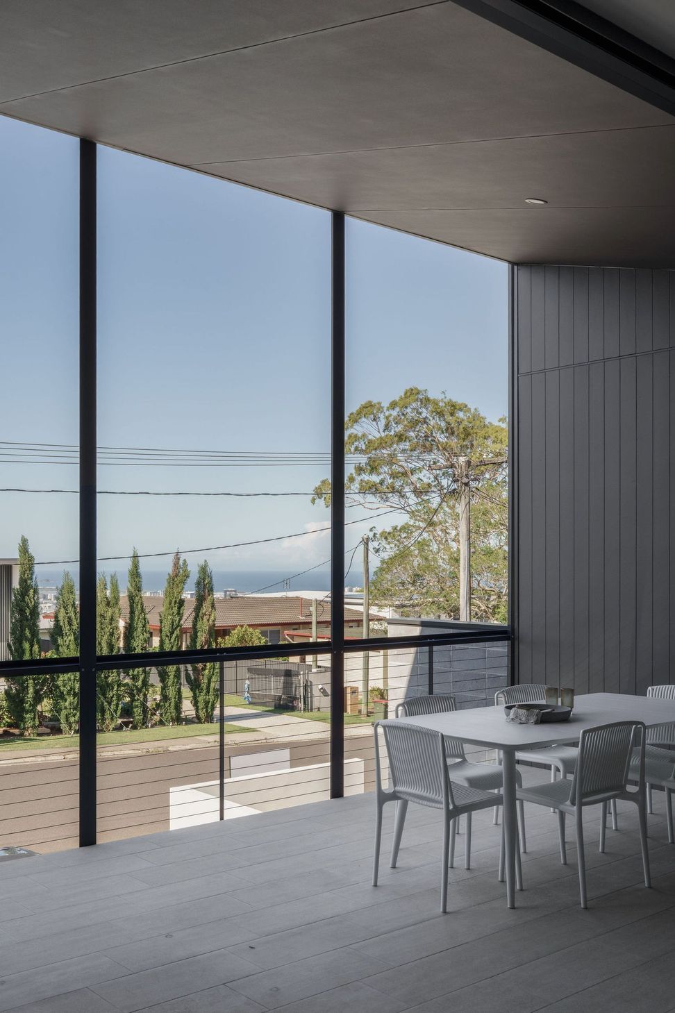 Gilbert Residence - Living Room. Full height glazing framing treetop and ocean views.