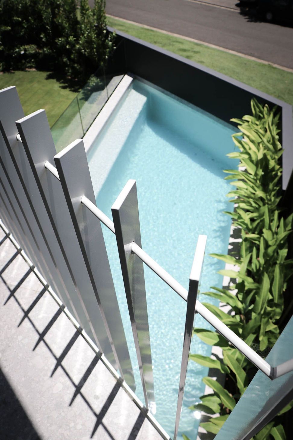 Shipp Residence - Pool. Pool glimpsed through slender white battens.