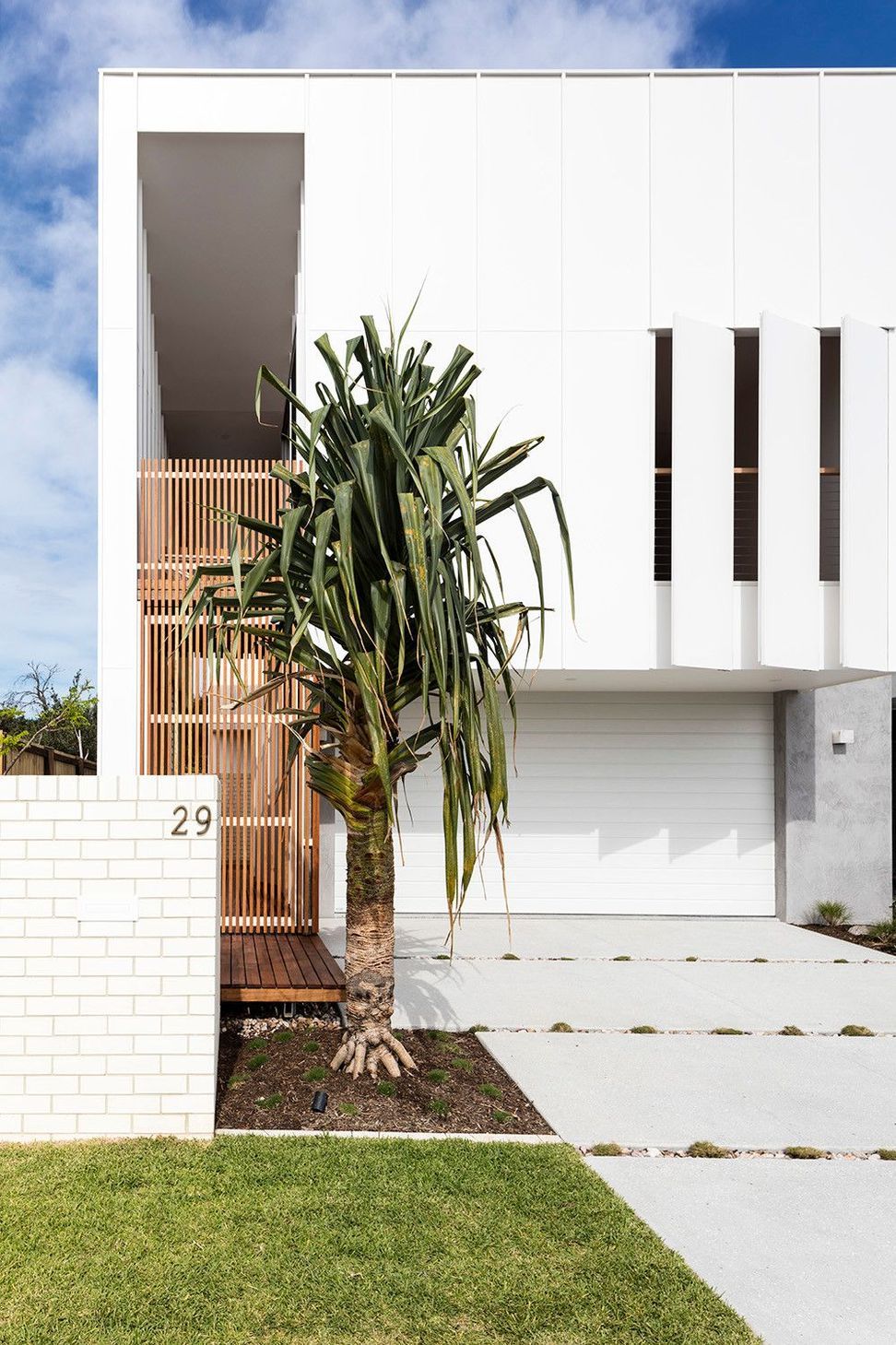 Viner Residence - Exterior. House number and pandanus beside the garage.