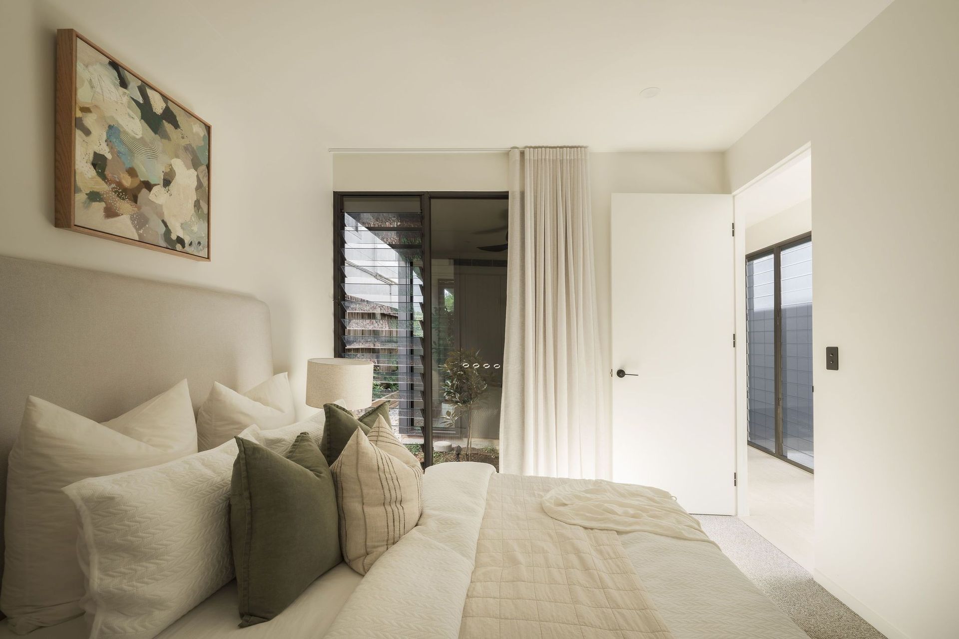 Gilbert Residence - Bedroom. Bedroom with layered neutral linen and sheer curtains.