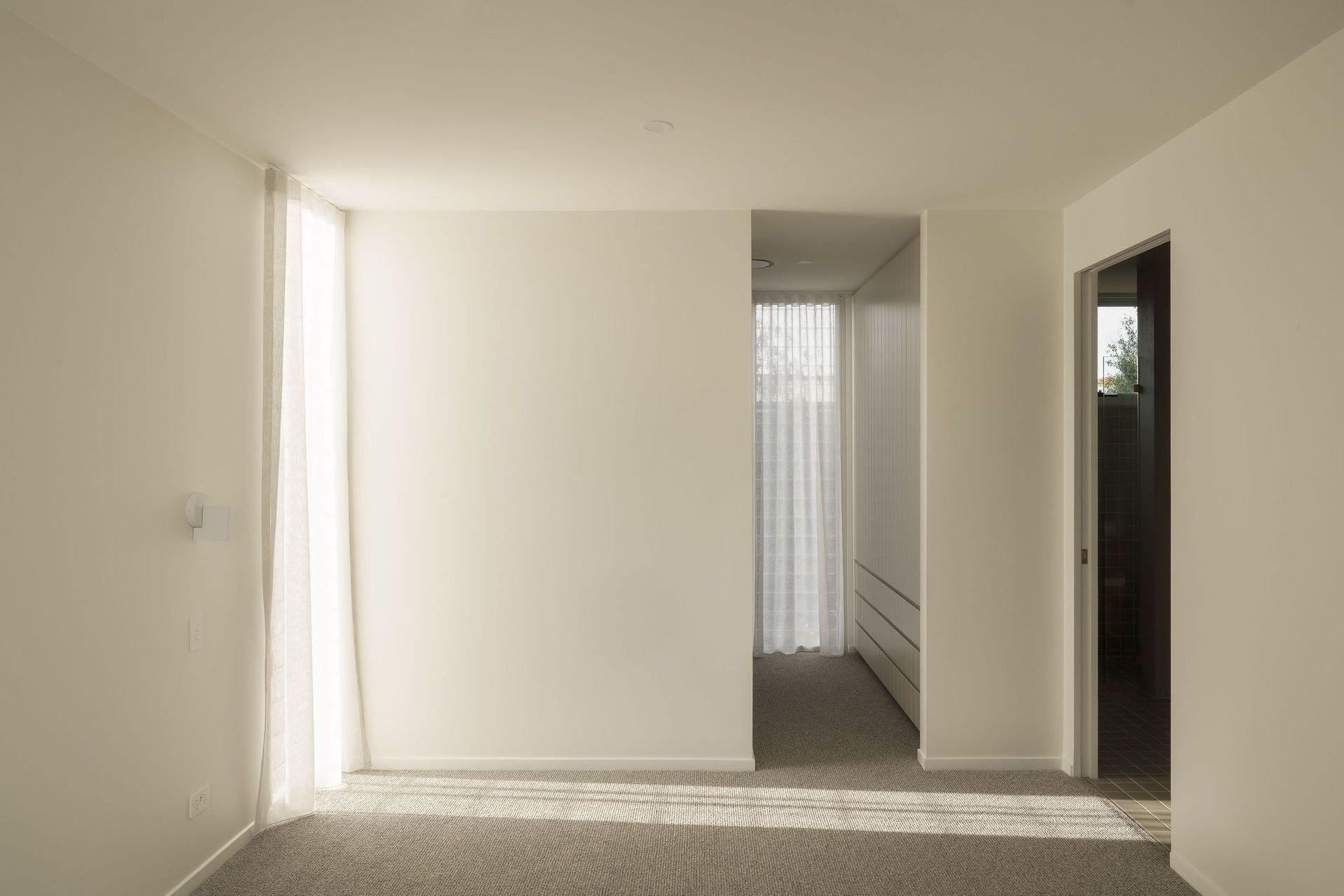 Gilbert Residence - Hall. Light filled hallway with soft white walls.