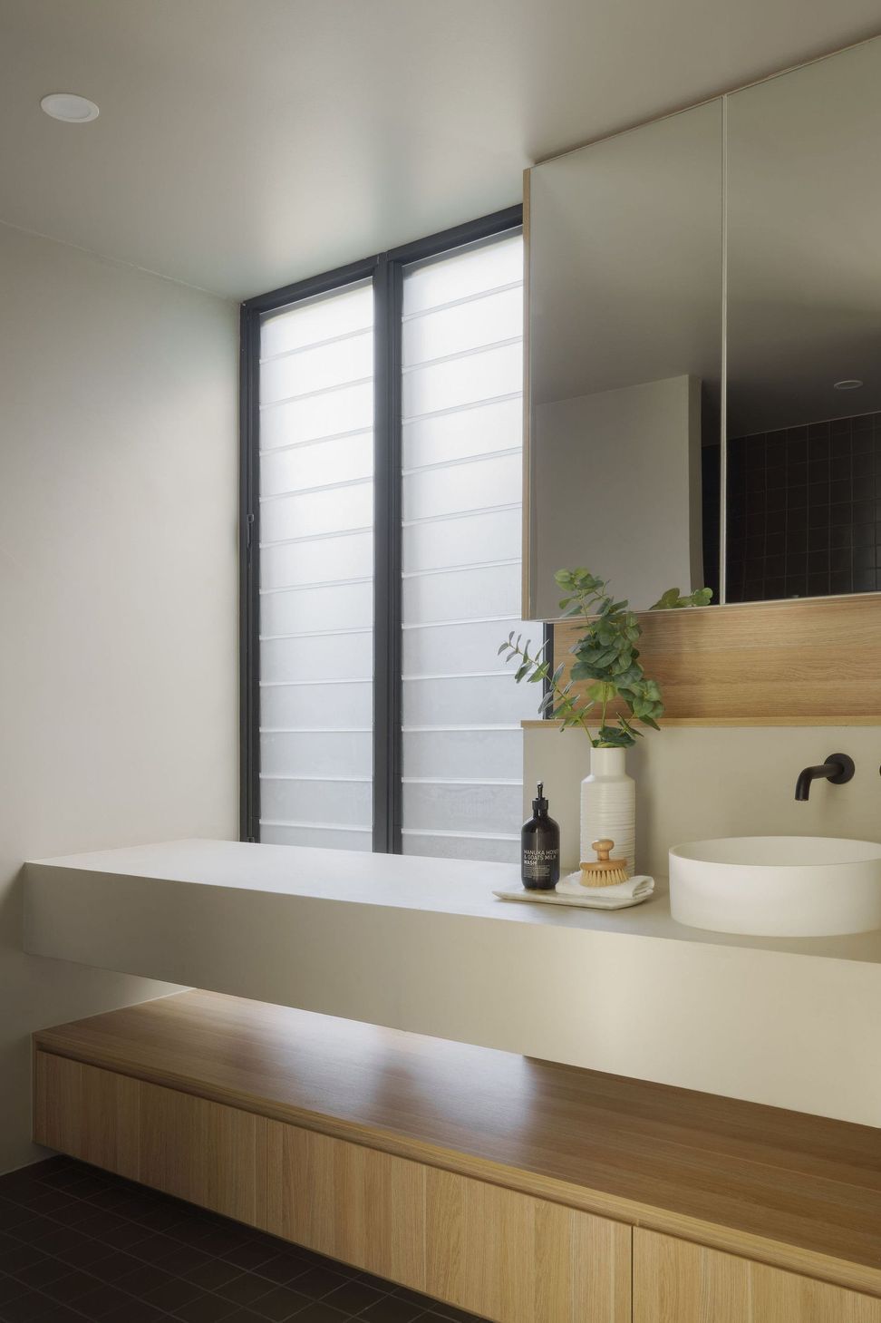 Gilbert Residence - Bathroom. Vanity and basin beneath louvred windows.