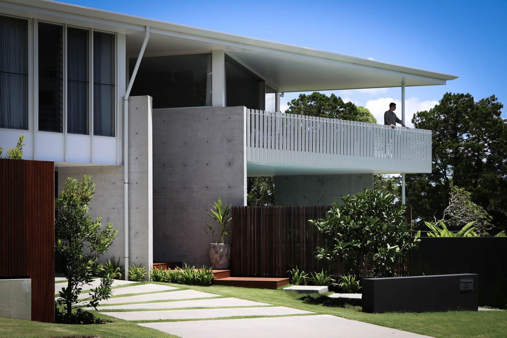 Shipp Residence - Exterior. Facade with timber screens, concrete and lush garden beds.