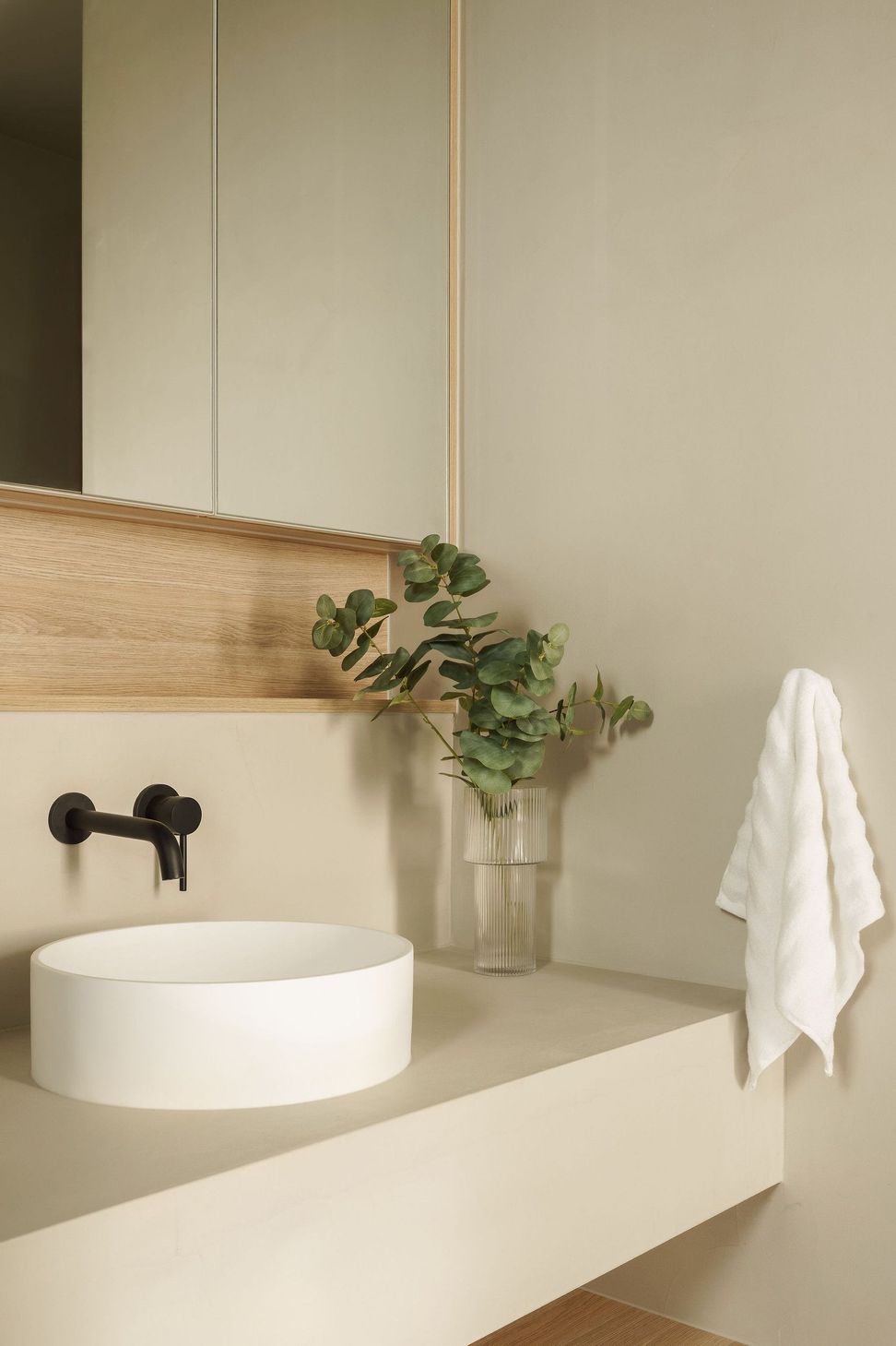 Gilbert Residence - Bathroom. Black wall mounted tapware above a stone basin.