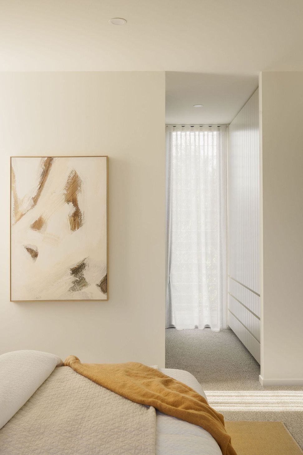Gilbert Residence - Hall. Abstract artwork beside sheer curtained windows.