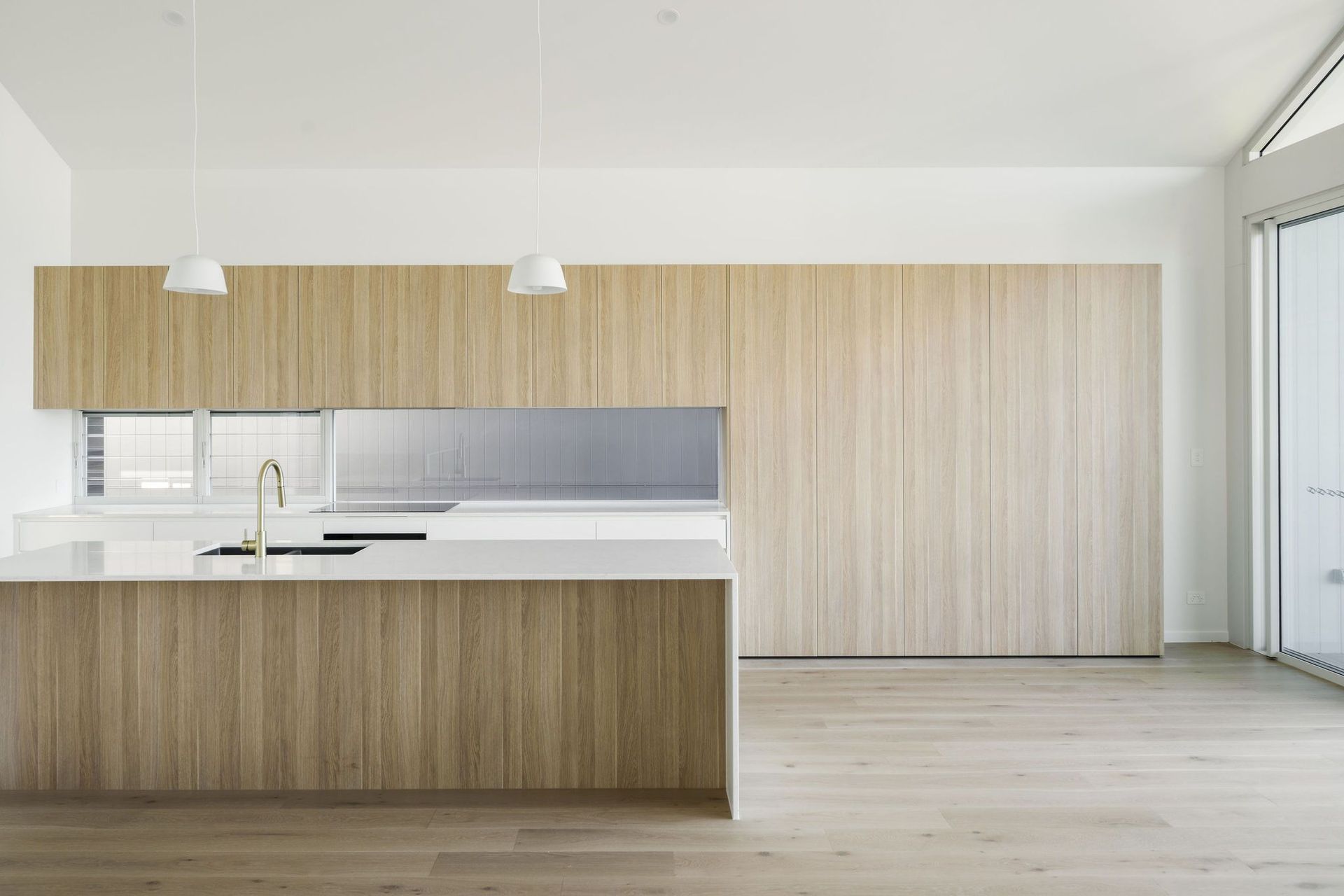 Gilbert Residence - Kitchen. Timber kitchen island with a white benchtop.
