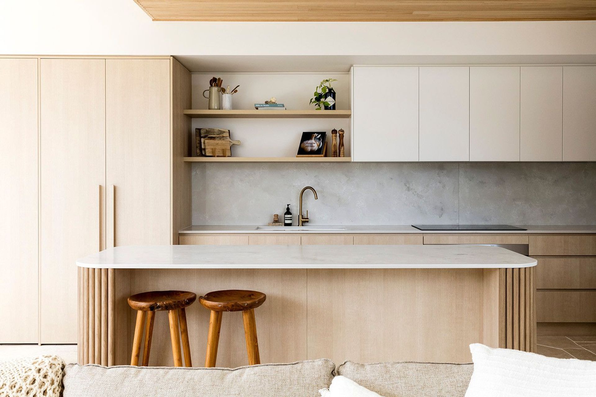 Viner Residence - Kitchen. Island bench with timber stools and open shelving.