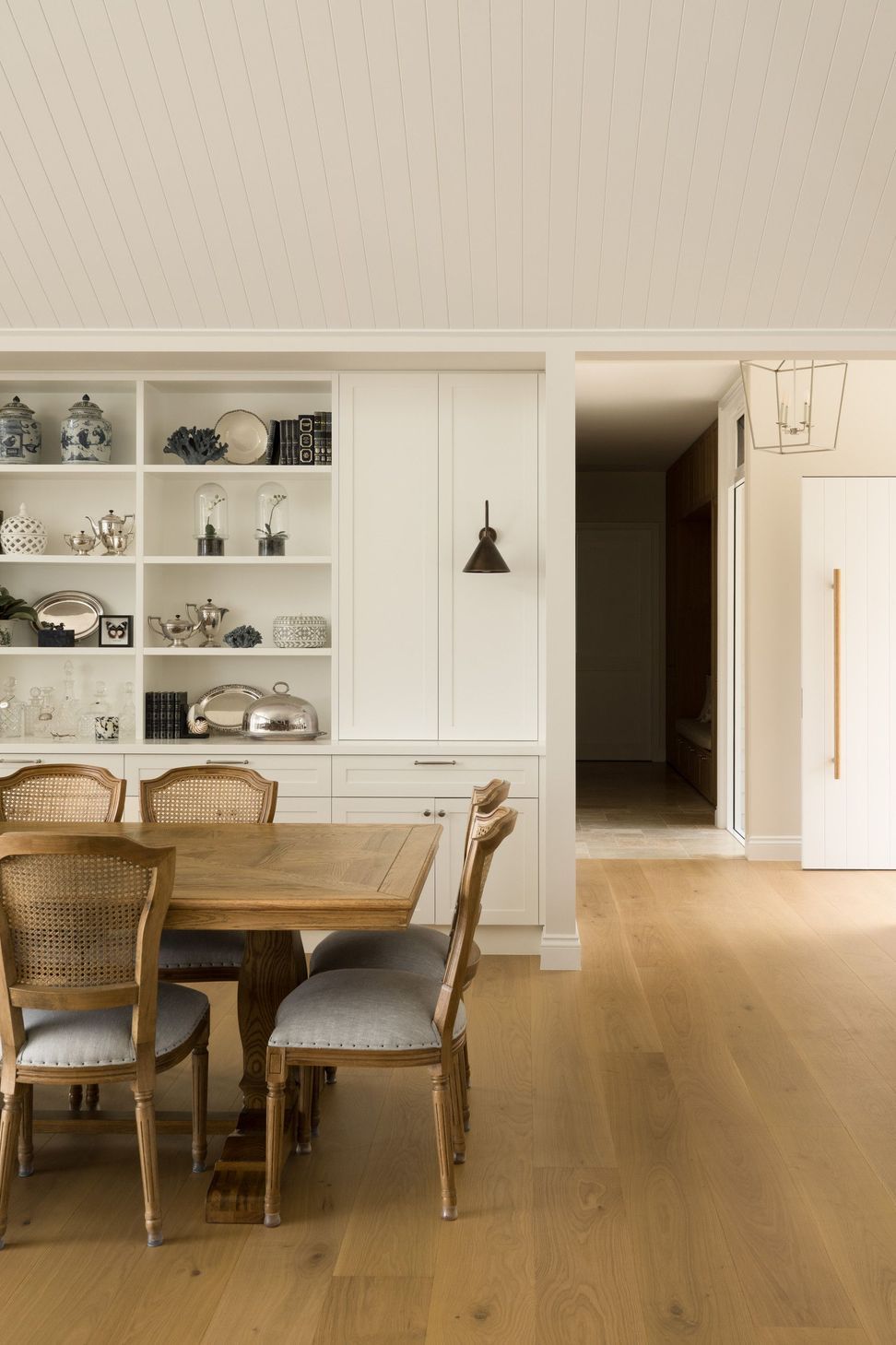 Euroa Farm - Dining Room. Display shelving and dining setting beside the hall.