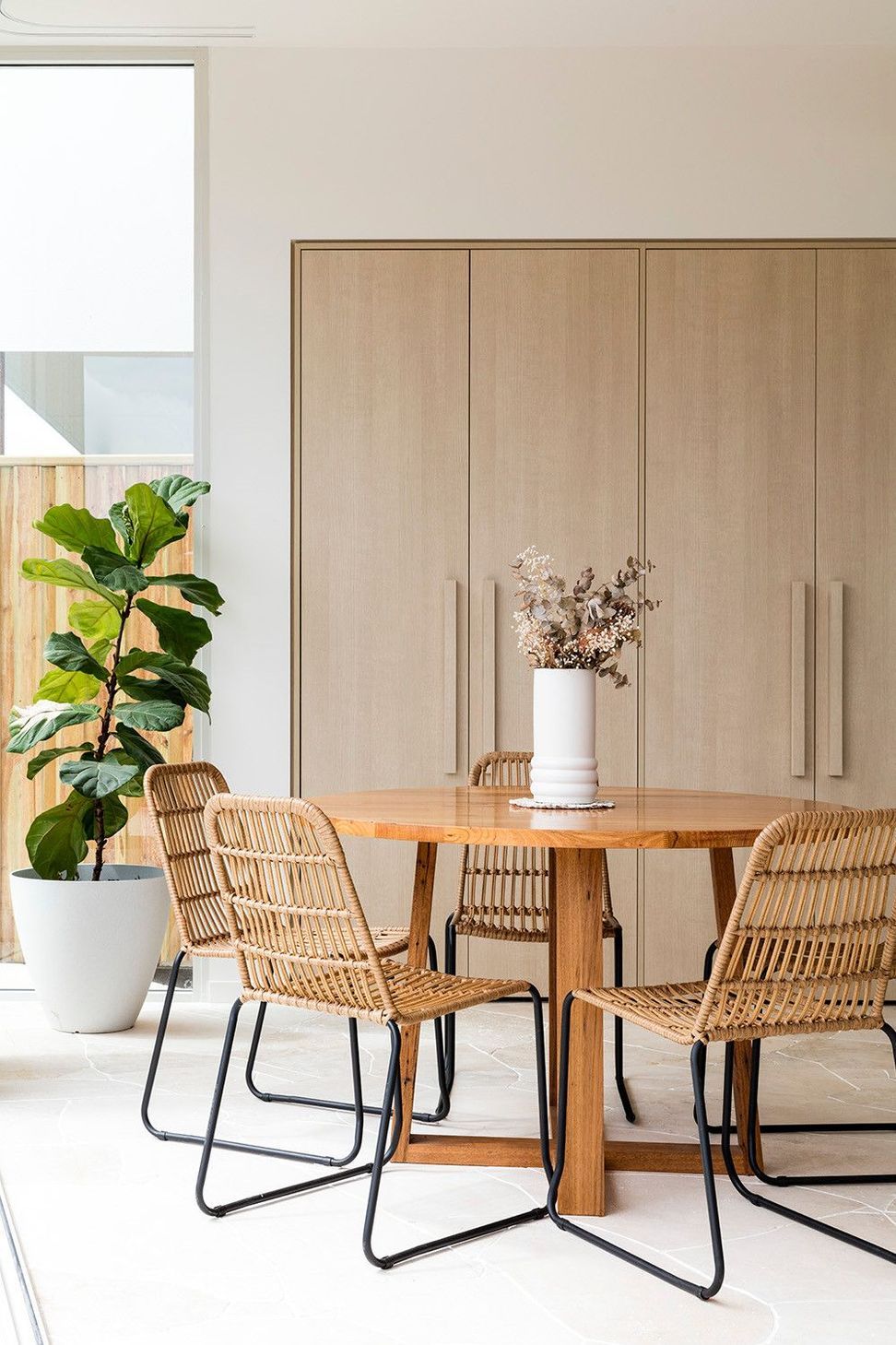 Viner Residence - Dining Room. Rattan dining chairs and a fiddle leaf fig.