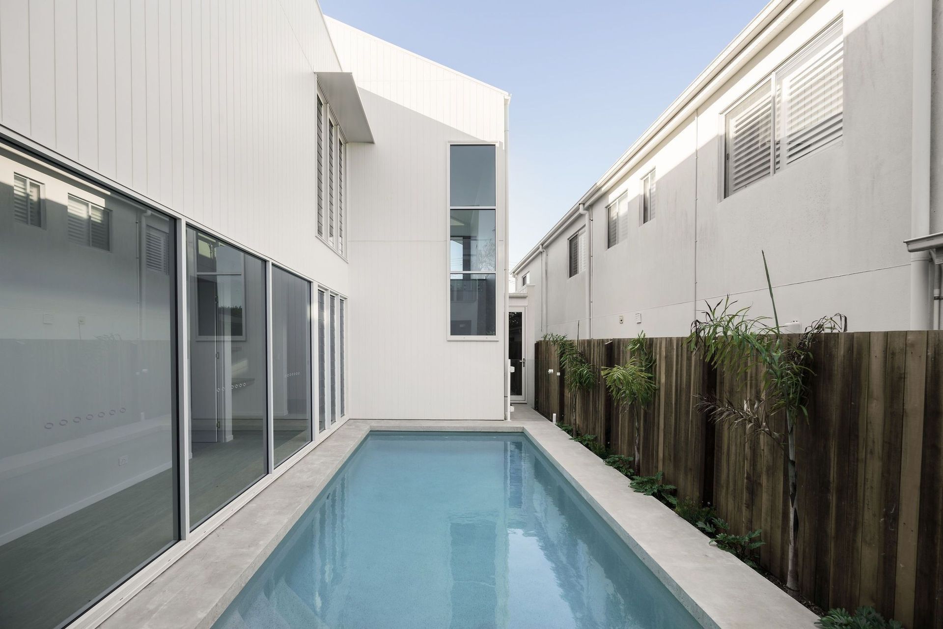 Gilbert Residence - Pool. Lap pool between the home and a timber fence.