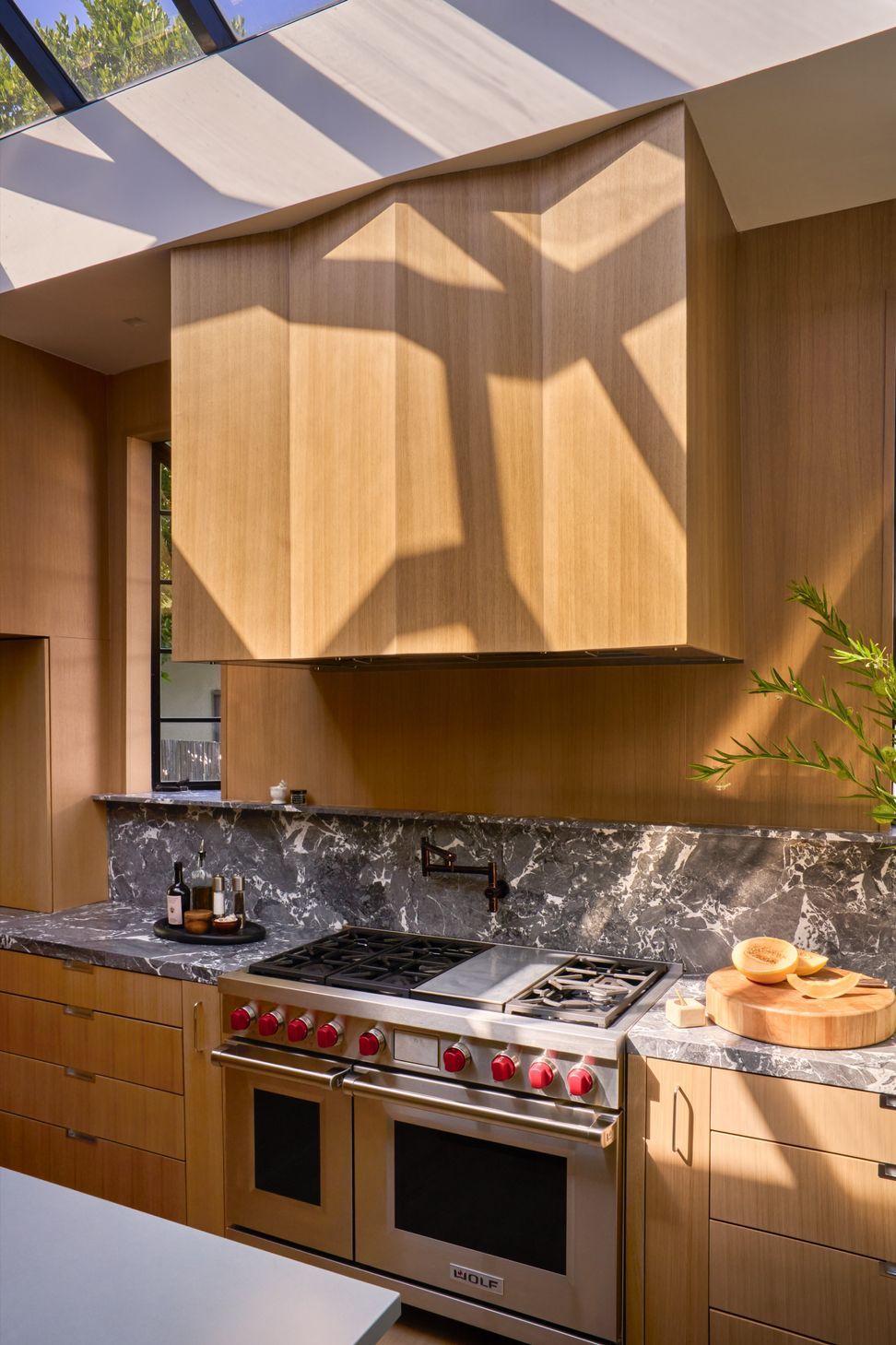 dona-marta-the-warren-interior-design-mid-century-modern-kitchen-faceted-wood-range-hood-wolf-range-20-studio-city-ap-compressed.jpg
