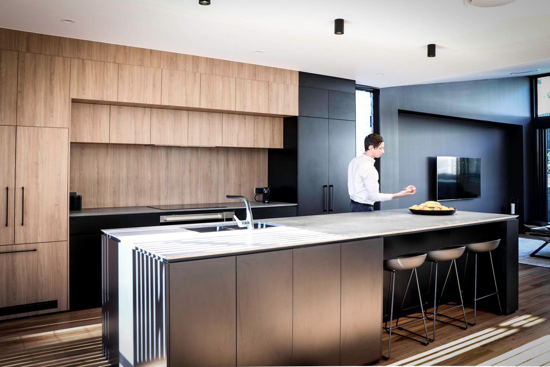 Glennon Residence - Kitchen. Timber and dark kitchen with a long island.