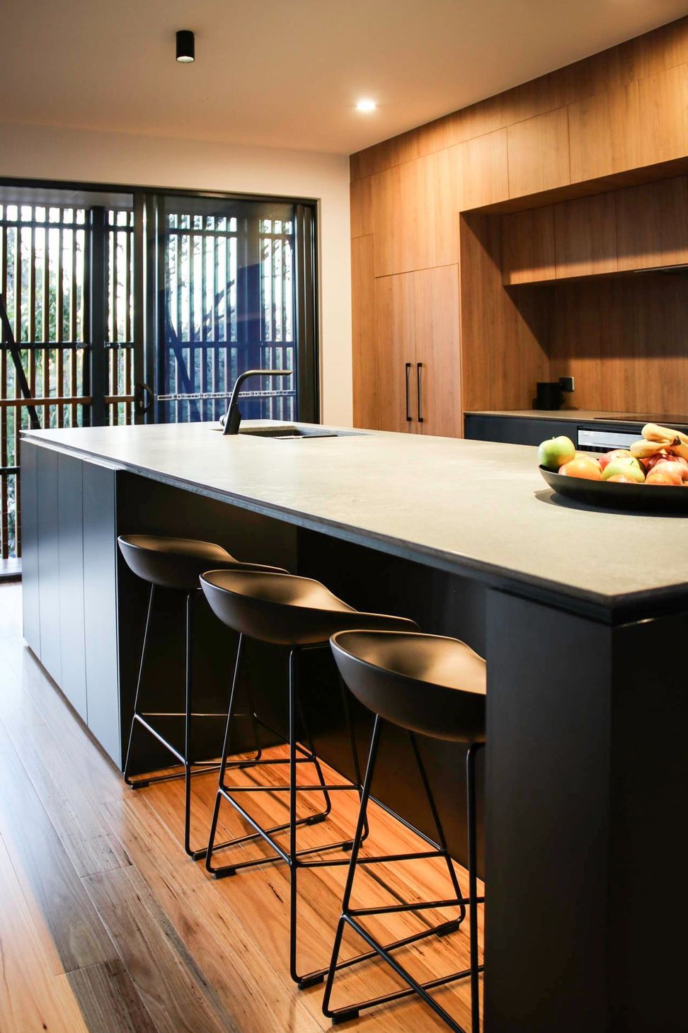 Glennon Residence - Kitchen. Concrete benchtop island with leather stools.