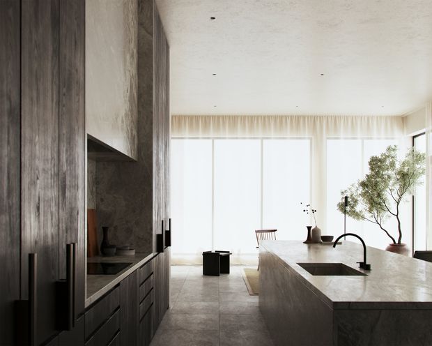 Bright, refined contemporary kitchen with a large stone island, integrated undermount sink and black gooseneck tap. Floor-to-ceiling windows with sheer curtains fill the open space with natural light, while dark vertically grained timber cabinetry and a dark stone or concrete-look wall provide contrast. A dining area and indoor trees are visible beyond the island.