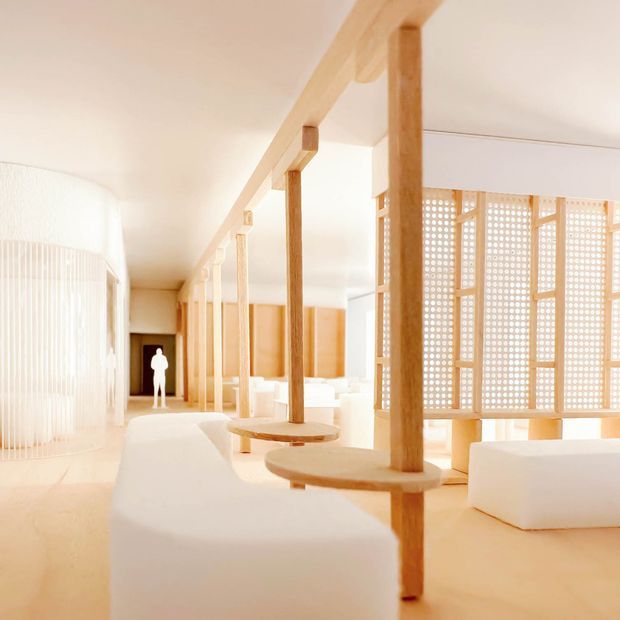 A bright, minimalist open-plan interior featuring warm timber posts and beams, white sculptural seating, pale flooring, and a perforated timber screen dividing the space. Soft daylight, curved partitions, and repeated structural columns create an airy, serene architectural setting.