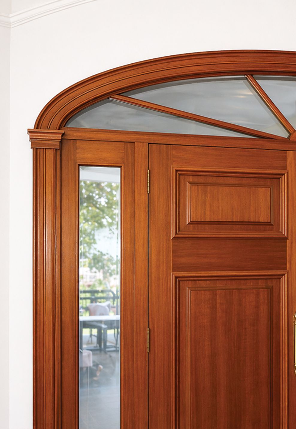 Custom curved timber entry door with arched transom, featuring seamless profile integration and refined joinery for a premium architectural entrance.