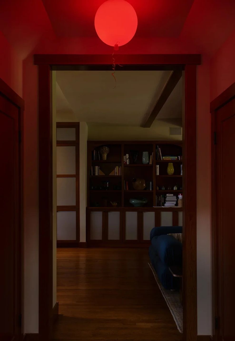 hallway-red-orb-light-wood-cabinetry-blue-sofa-pacific-palisadeswebp-ap-compressed-v2.jpg