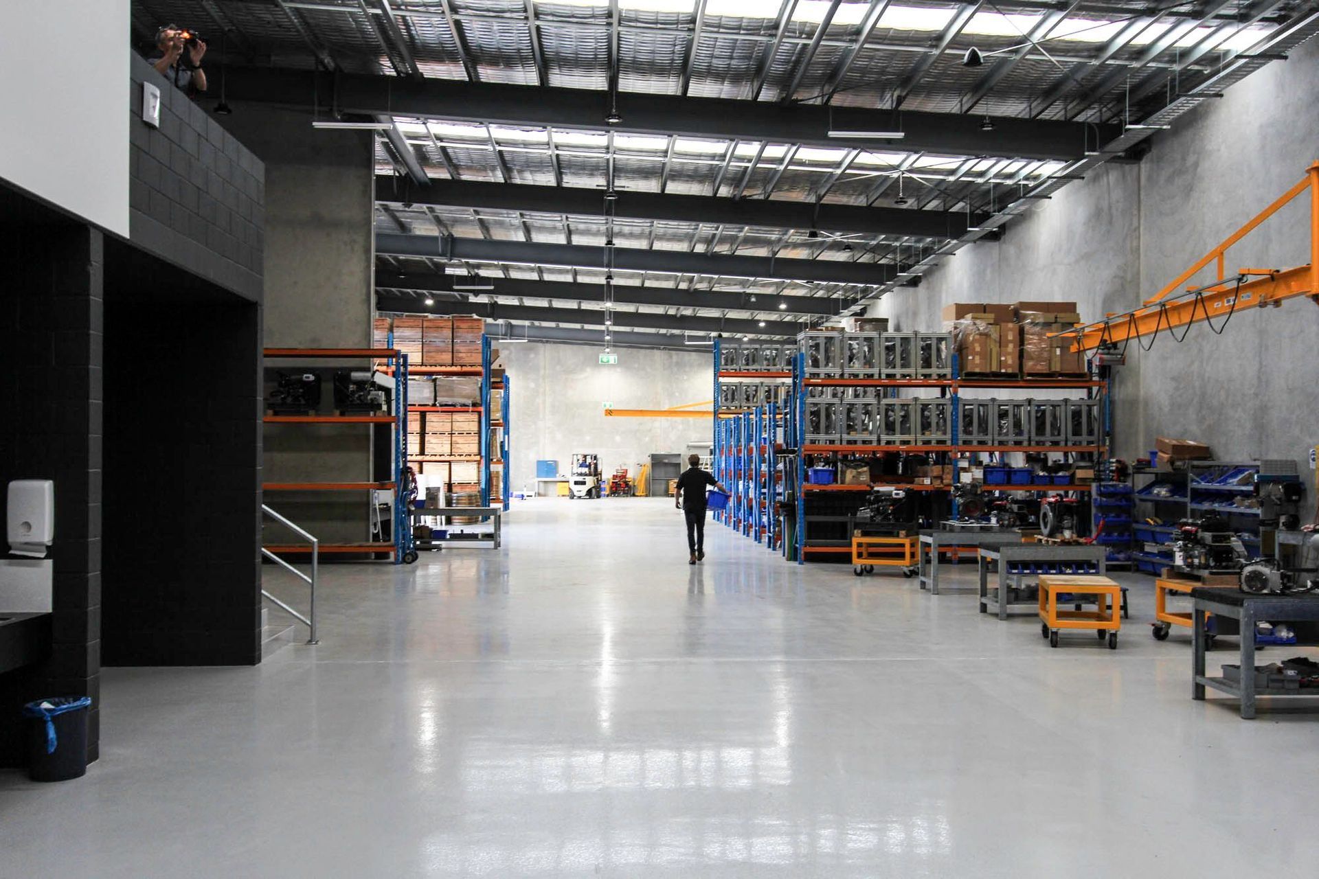 Eniquest Warehouse - Warehouse. Long warehouse aisle beneath skylights.