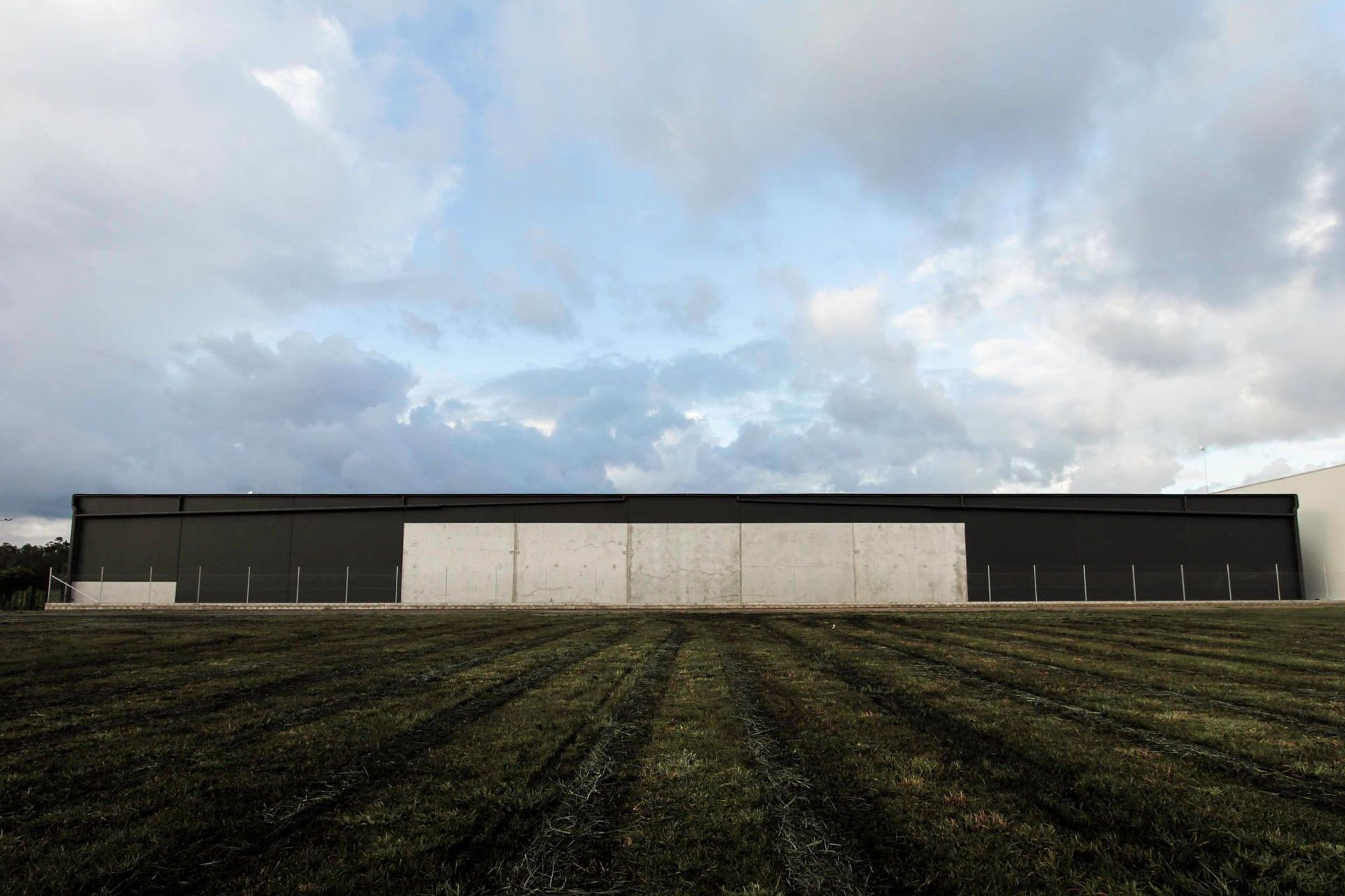 Eniquest Warehouse - Exterior. The building on the horizon at dusk.