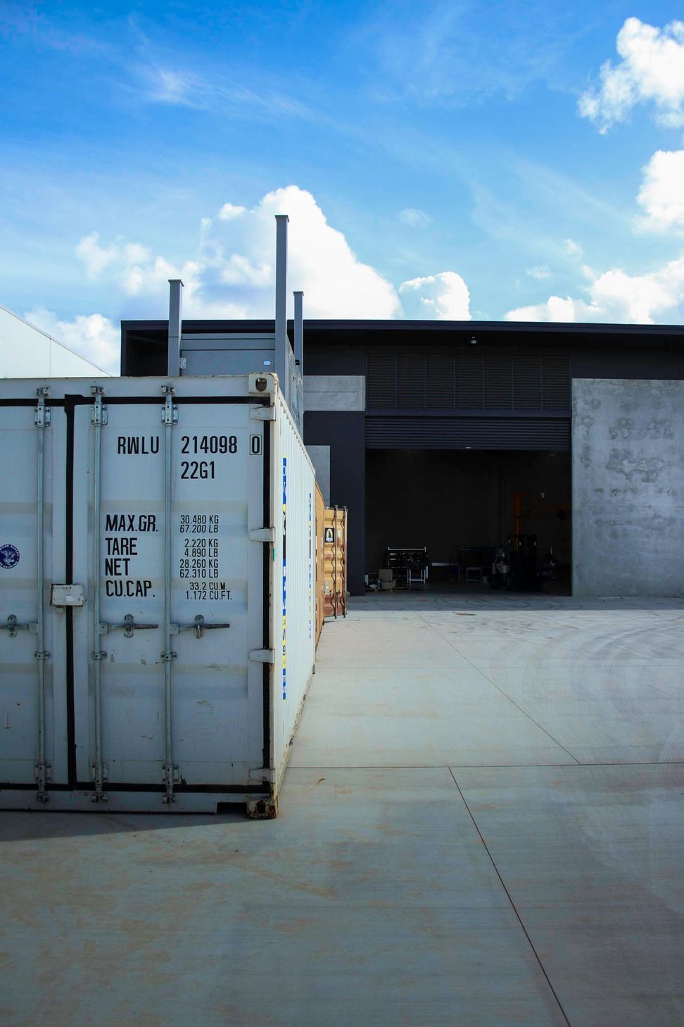 Eniquest Warehouse - Exterior. Shipping container outside the warehouse doors.