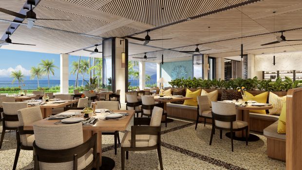 A spacious open-air coastal restaurant or resort dining venue with extensive ocean views, timber dining tables, upholstered chairs, built-in banquette seating, abundant planter greenery, and a slatted timber ceiling with multiple ceiling fans. The interior uses warm natural materials and a relaxed tropical-resort aesthetic.