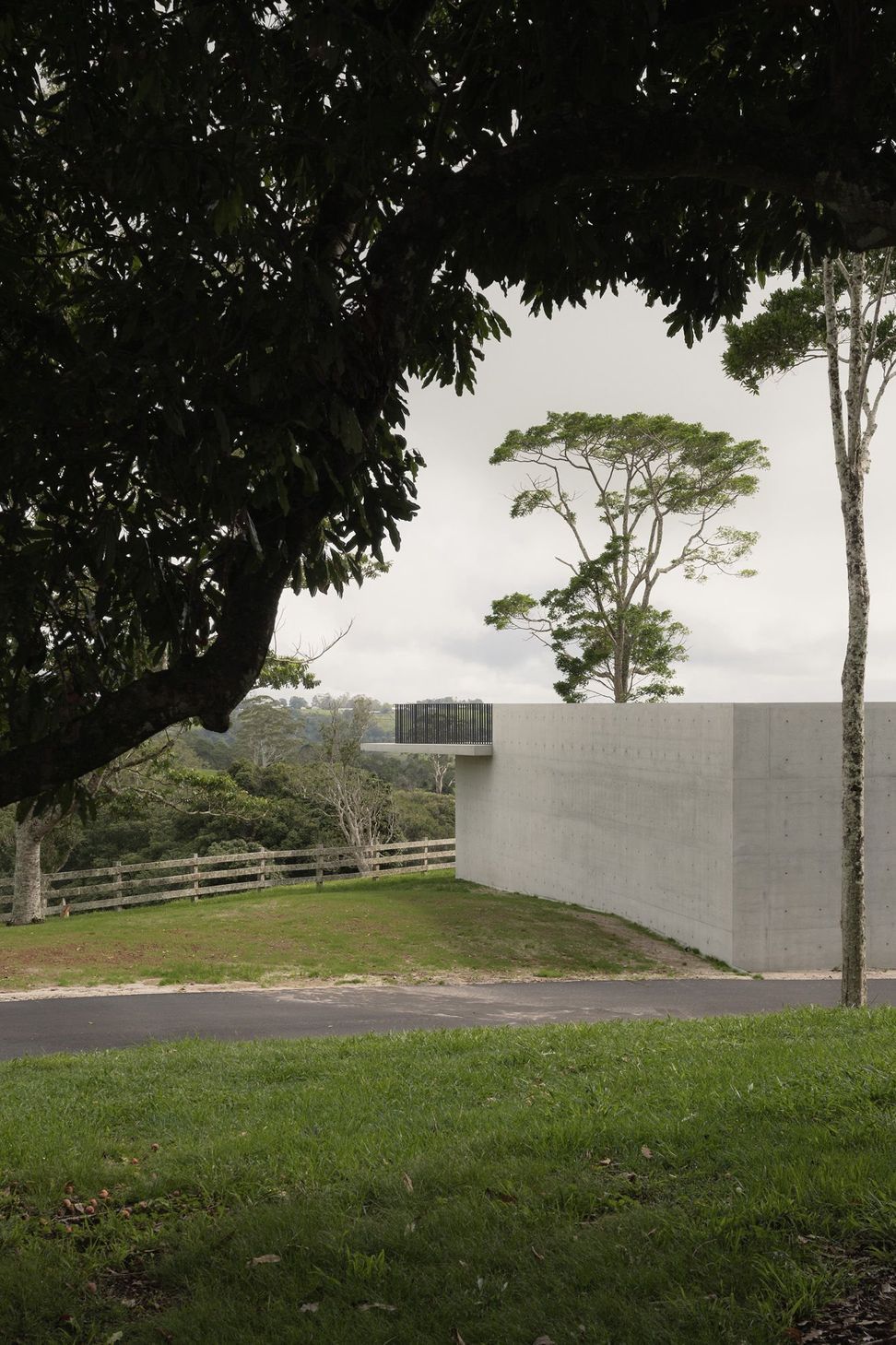 The Farm - Exterior. Off-form concrete pavilion set into the grassy slope.