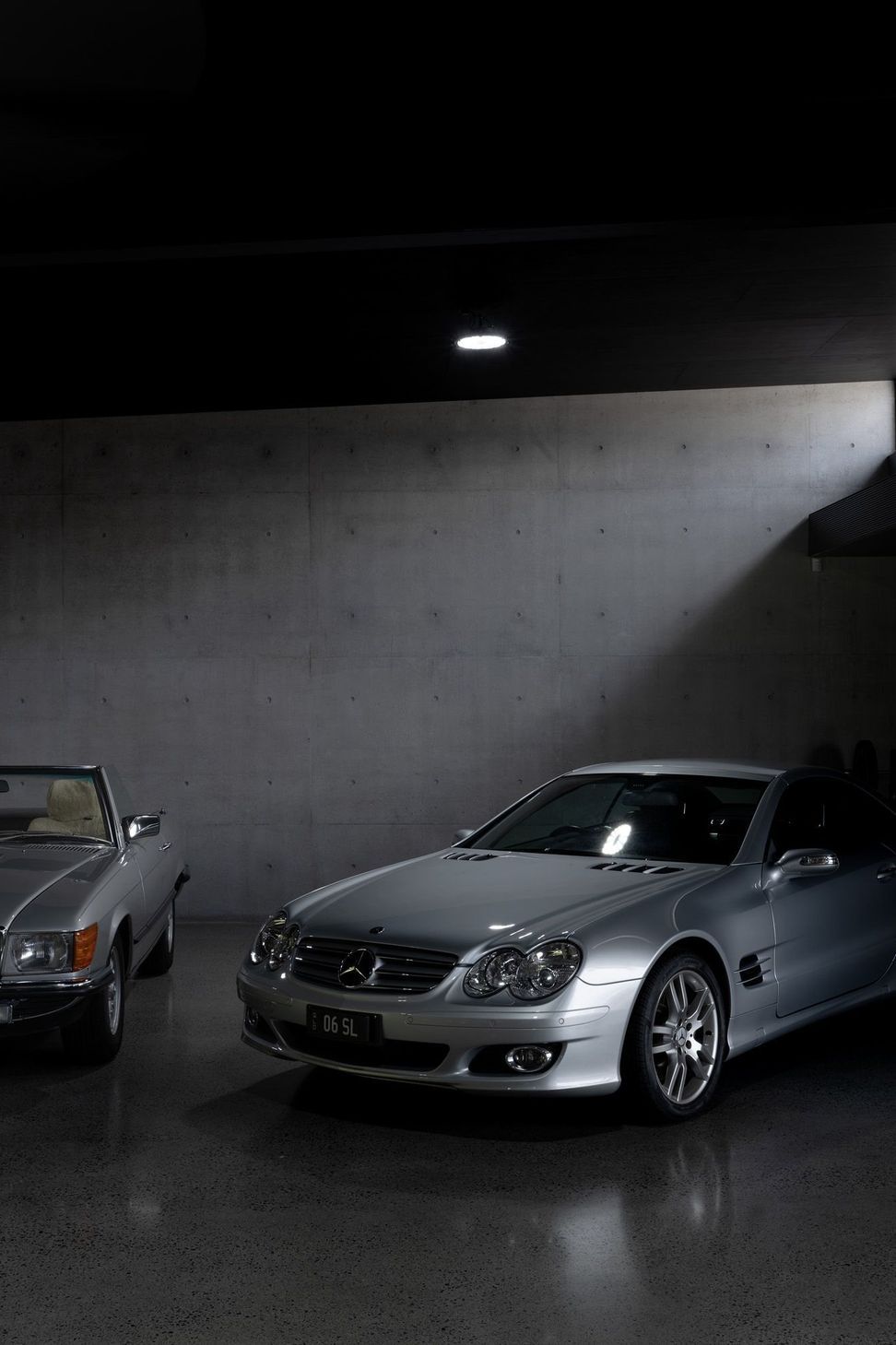 The Farm - Garage. Cars parked in the dark, top lit garage.