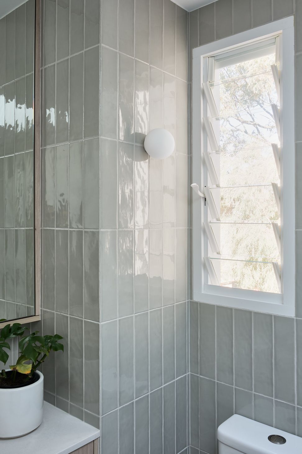 The tone enhances the natural feel connecting the interior with the tree canopy views through the windows.