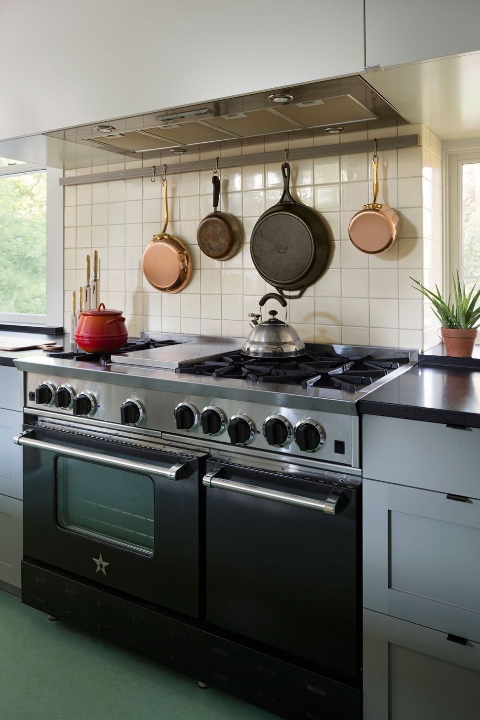 9TransformationinHemphillParkCuppettKilpatrickArchitectureandInteriorDesignaustin-tx-kitchen-black-steel-range-copper-pans.jpg