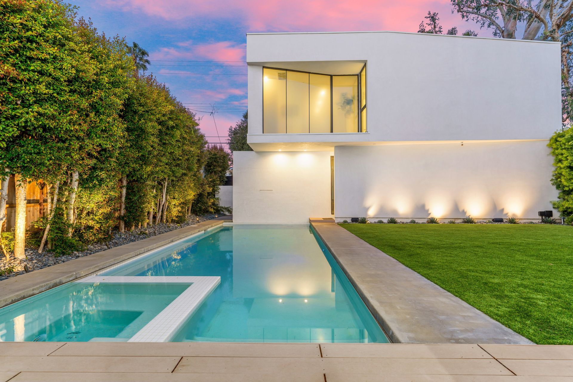 A backyard with a patio, lawn, and pool connects the renovated home and its garage, which has
been retrofitted with a two-bed ADU in a matching contemporary style.
