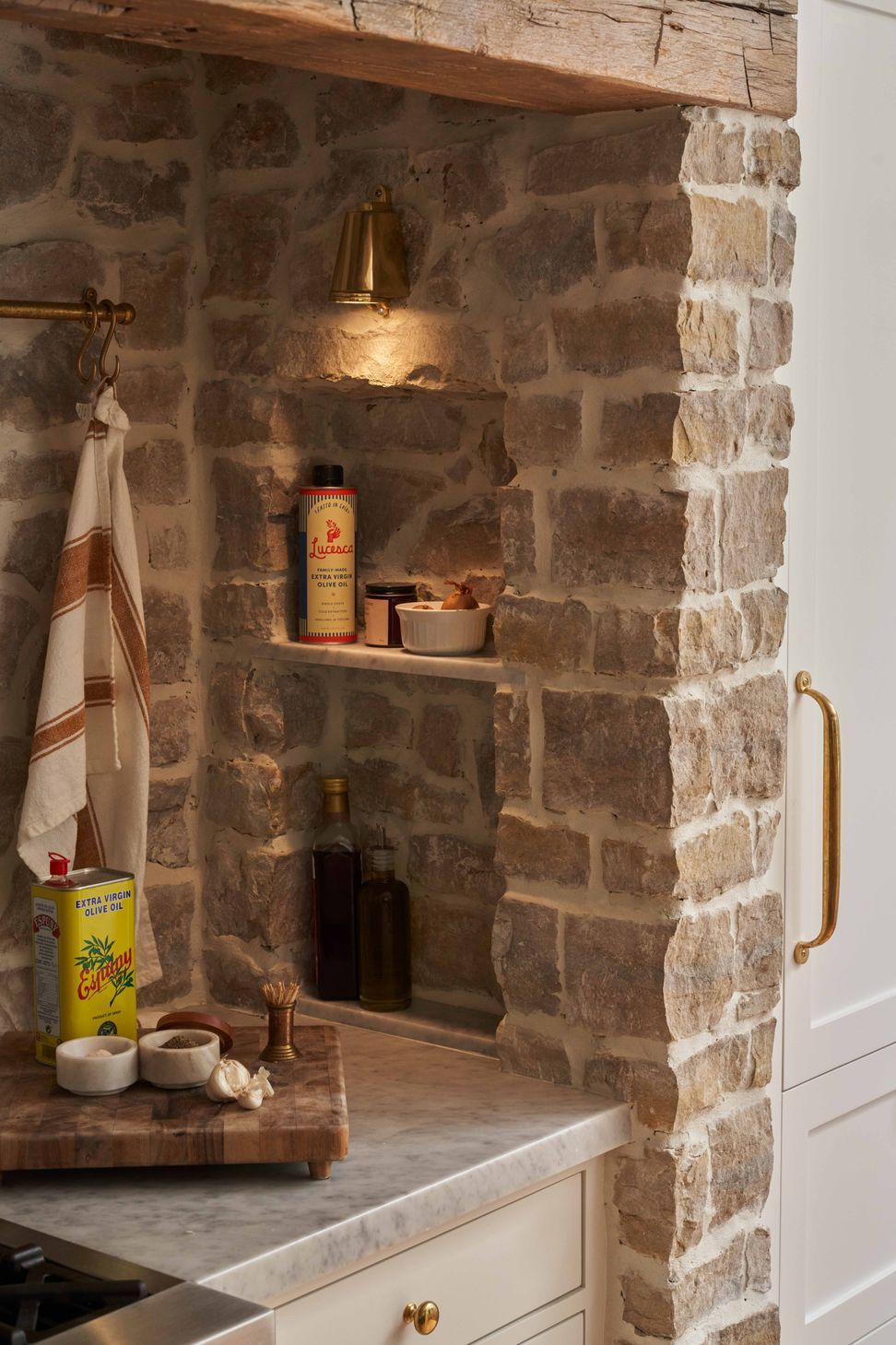 the-warren-linda-vista-english-cottage-kitchen-built-in-marble-shelves-brass-sconce-14.jpg