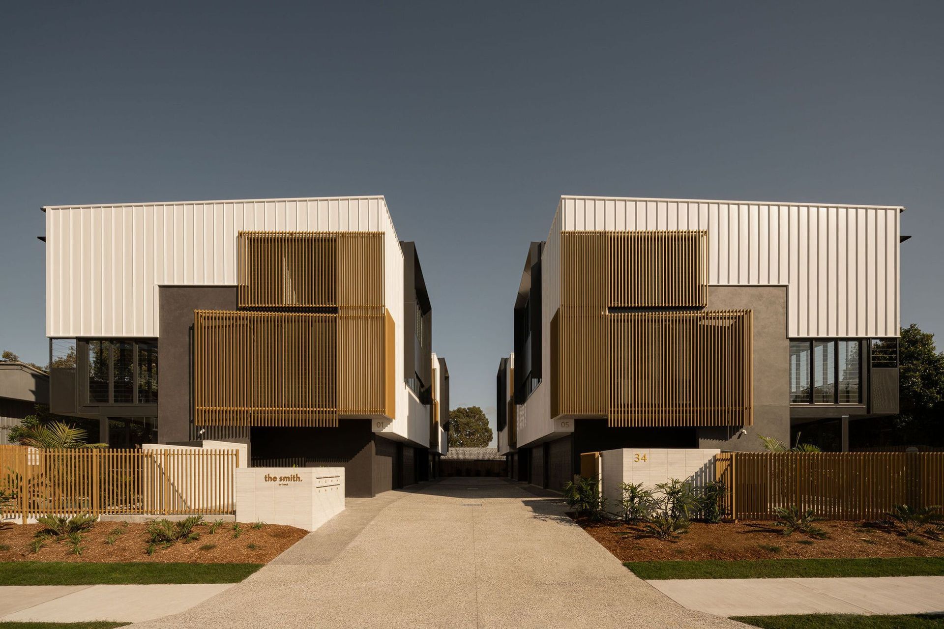 The Smith - Exterior. Central driveway between the two rows of townhouses.