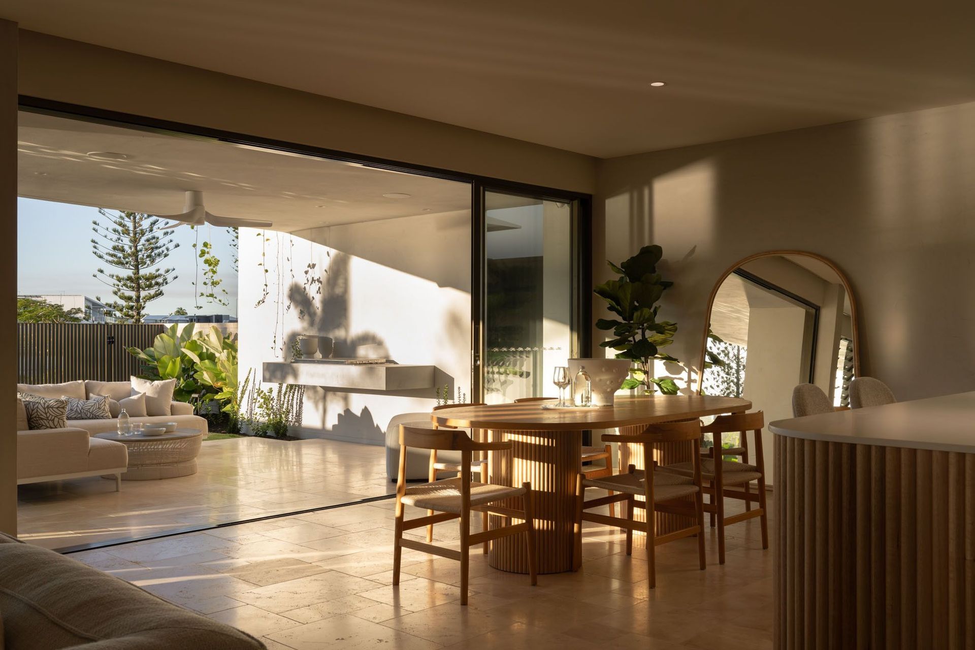 Warrego - Dining Room. Round timber dining table opening to the outdoor living area.