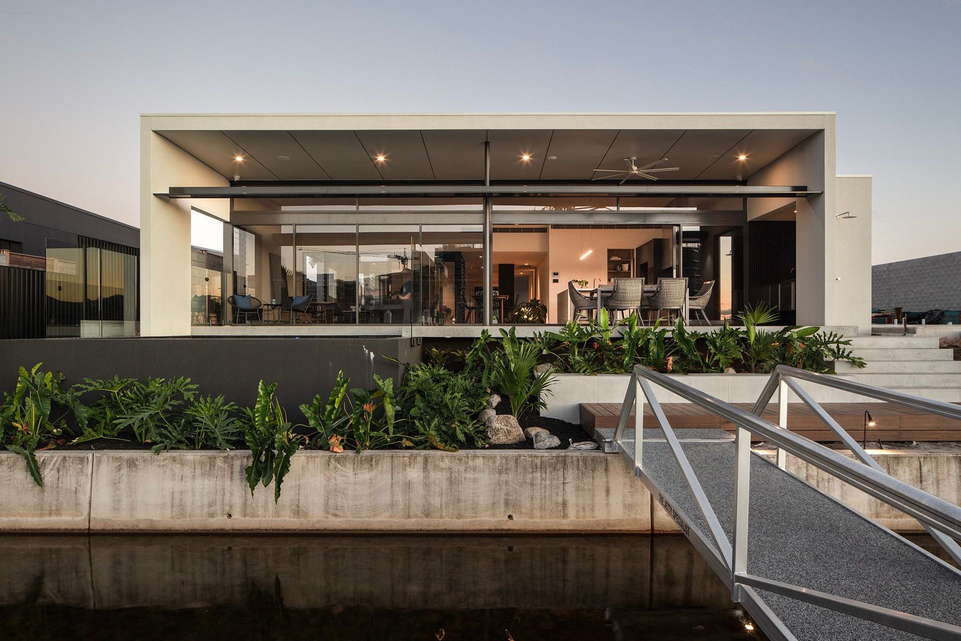 Bells Esplanade - Exterior. Glazed living pavilion behind a planted terrace.
