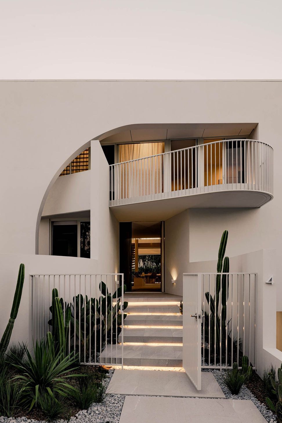 Zaremba Residence - Entry. Curved entry wall framing steps and native planting.