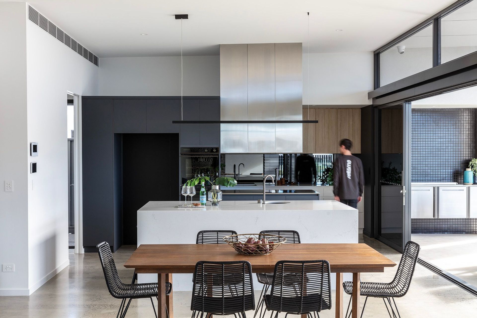 Bells Esplanade - Kitchen. Kitchen and dining with a stone island and pendant lights.