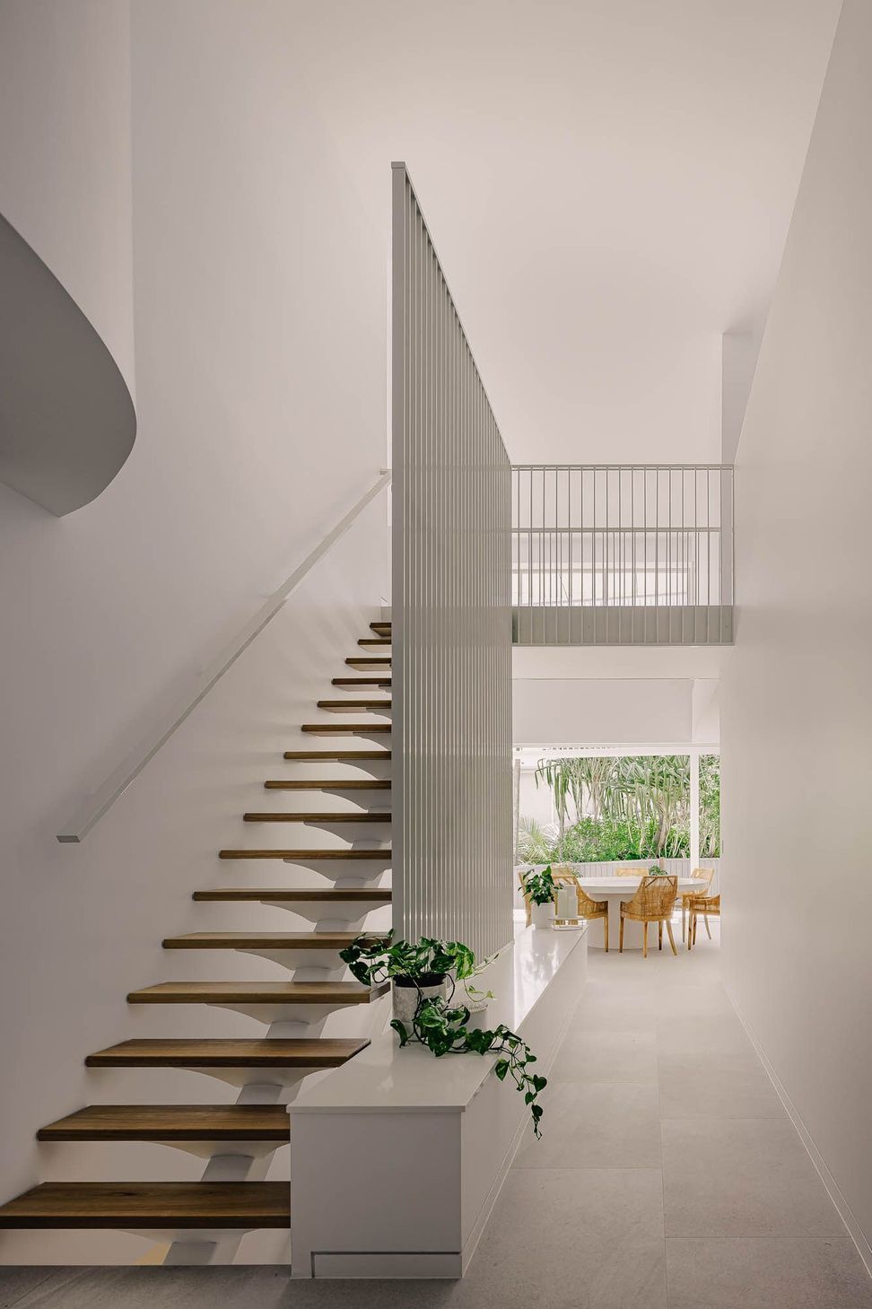 Zaremba Residence - Staircase. Floating timber stair against a white wall.
