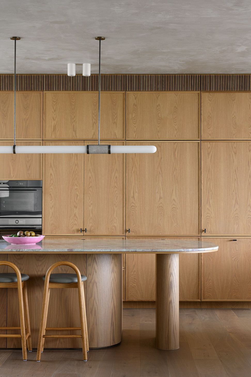 Villa Solare - Kitchen. Timber kitchen with integrated ovens and a stone island.