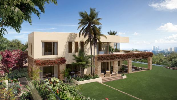 Exterior architectural rendering of a contemporary two-storey residence with a clean rectilinear form, pale rendered walls, extensive glazing, a deep upper terrace with planted screening, and a generous landscaped lawn. Tropical planting including palms and flowering shrubs surrounds the house, with a distant urban skyline visible beyond the garden.
