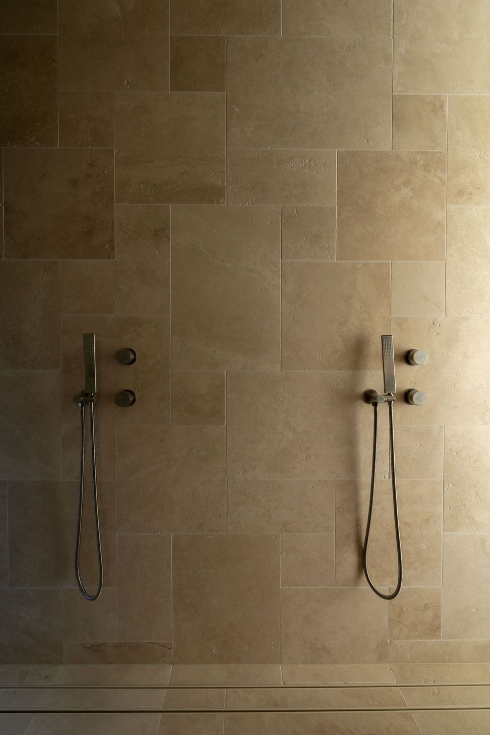 Warrego - Bathroom. Brushed shower fittings on stone toned tiles.
