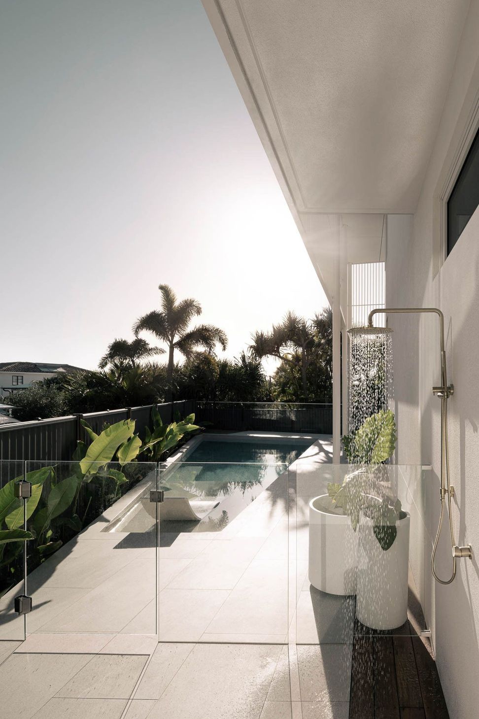 Zaremba Residence - Pool. Pool terrace edged by palms and lush planting.